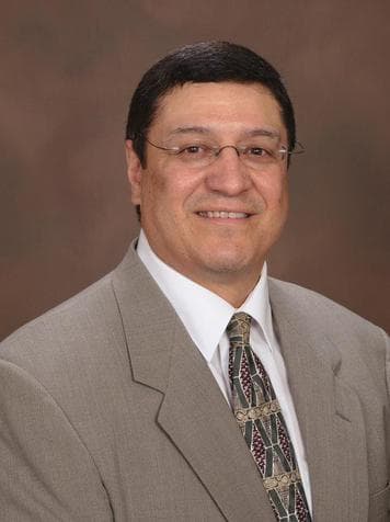 Dr. Jack E. Duran in a suit and tie.