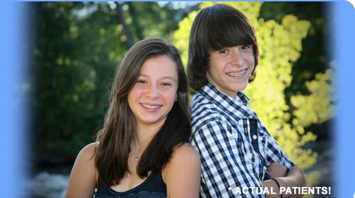 Two of the practice's patients, a teenage girl and boy, smiling in their braces.